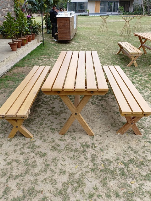 Wooden benches and picnic tables on a lawn