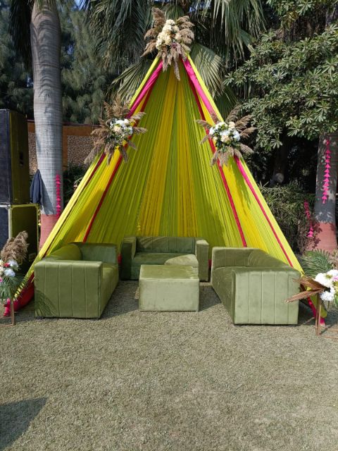 Striped cabana with low seating on a lawn