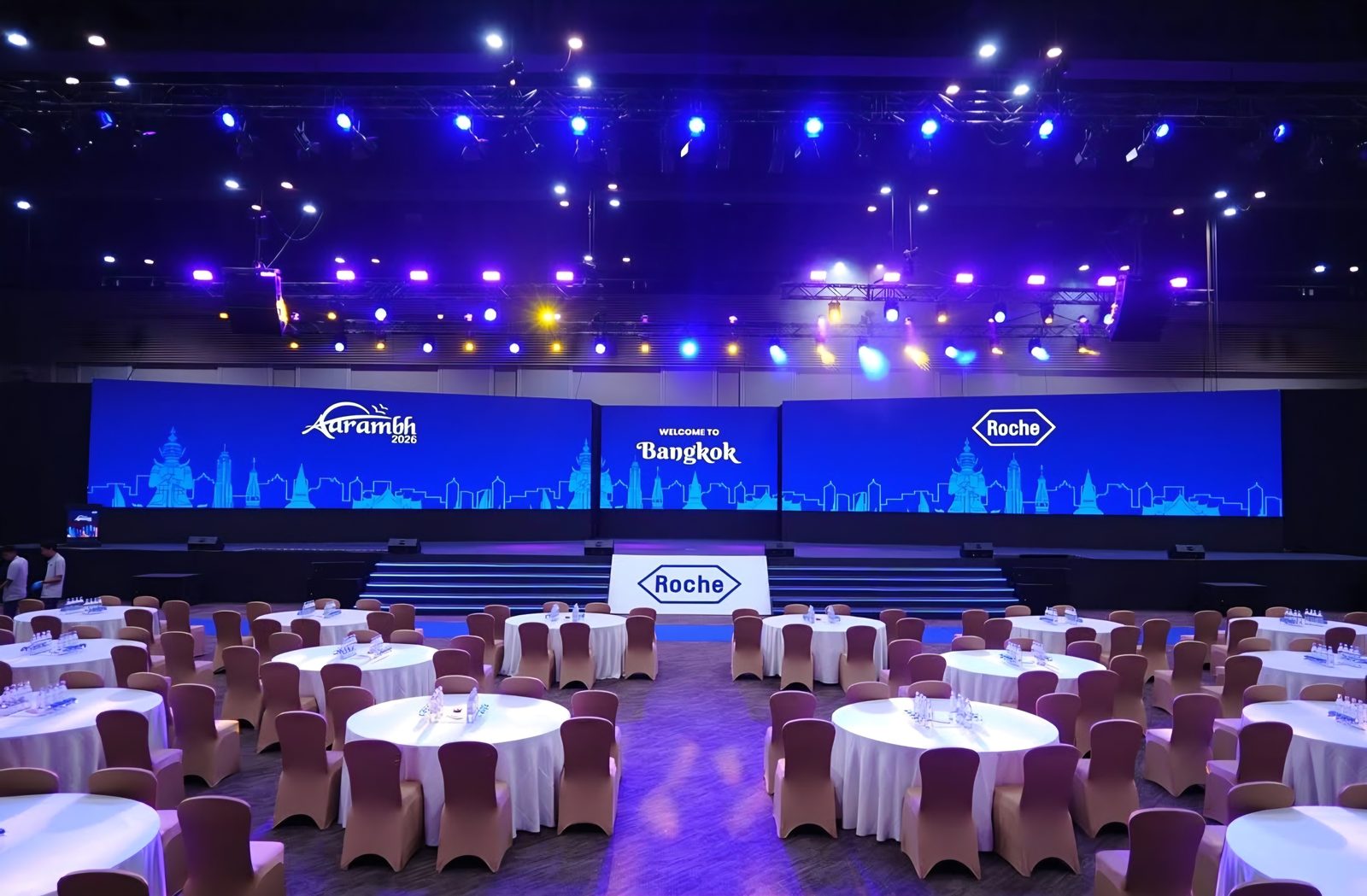 Conference ballroom with an LED stage and round-table seating