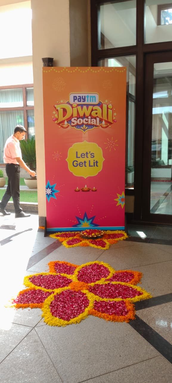 Rangoli and branded standee at an office Diwali