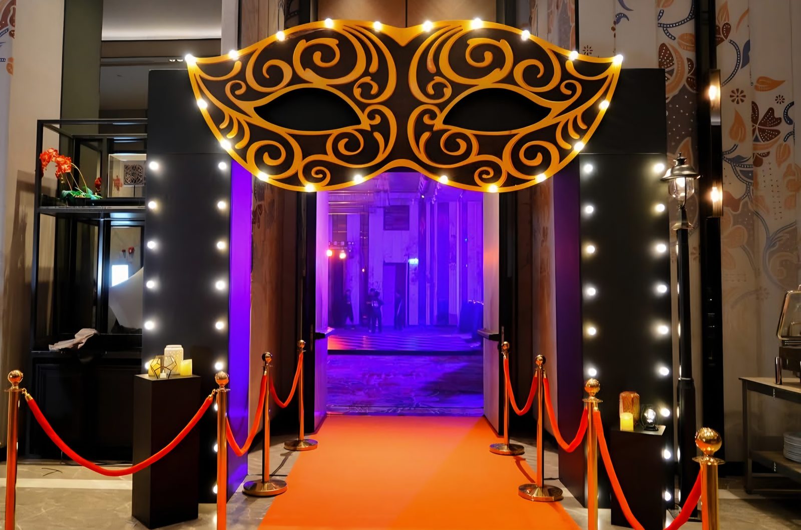 Masquerade entry arch with a lit walkway